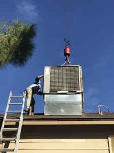Patriot Air's men installing a new hvac unit